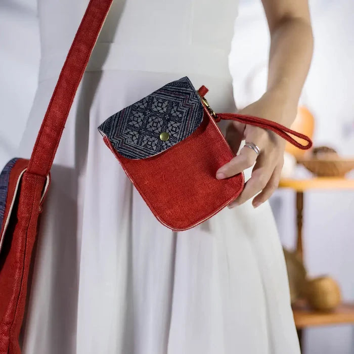 Red hemp flip phone belt bag (mobilväska) worn as wrist bag with vintage H’Mong patch, handmade eco-friendly design