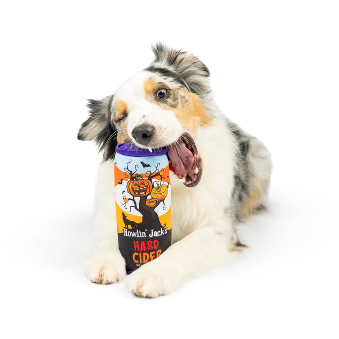 Dog playing with an orange can-shaped plush toy featuring Howlin' Jack's Hard Cider (Double Sided).