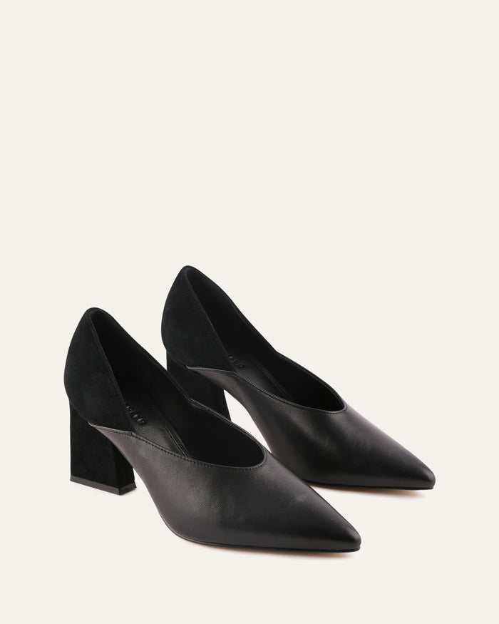 Pair of black high-heeled shoes on a light beige background