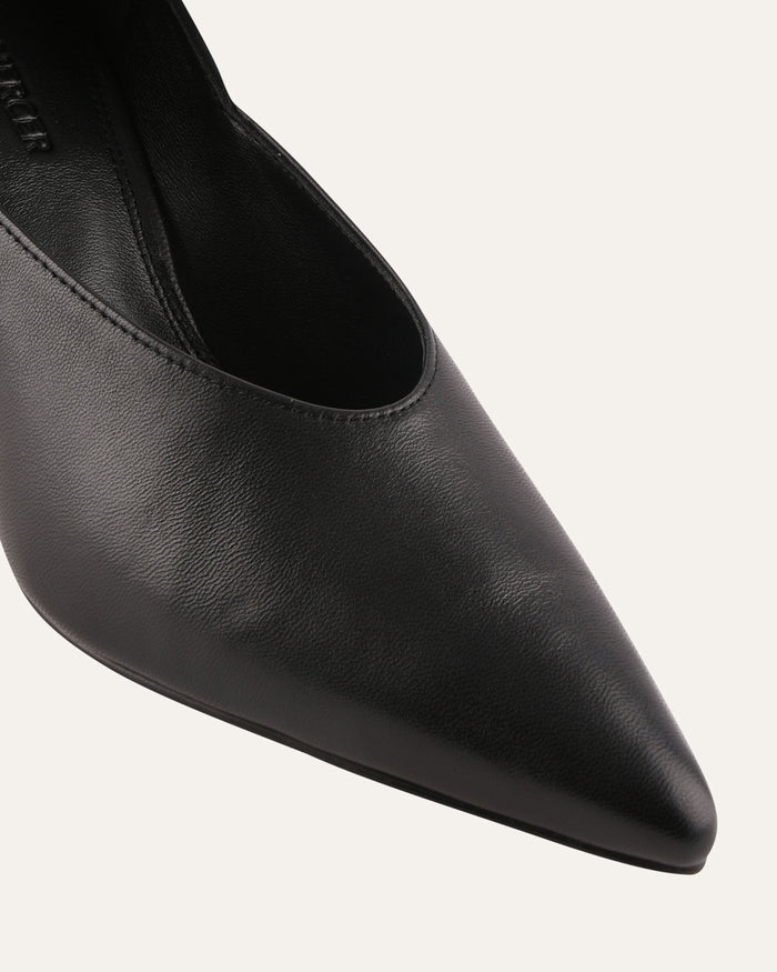 Black pointed-toe shoe on a light gray background