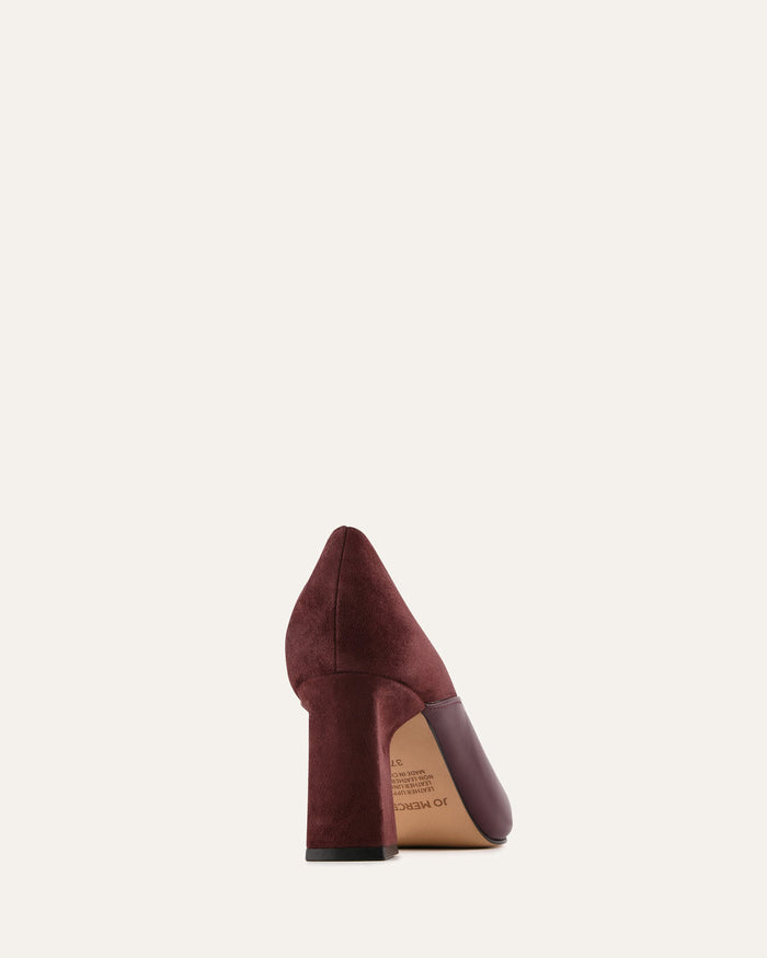 Maroon high-heeled shoe on a light beige background