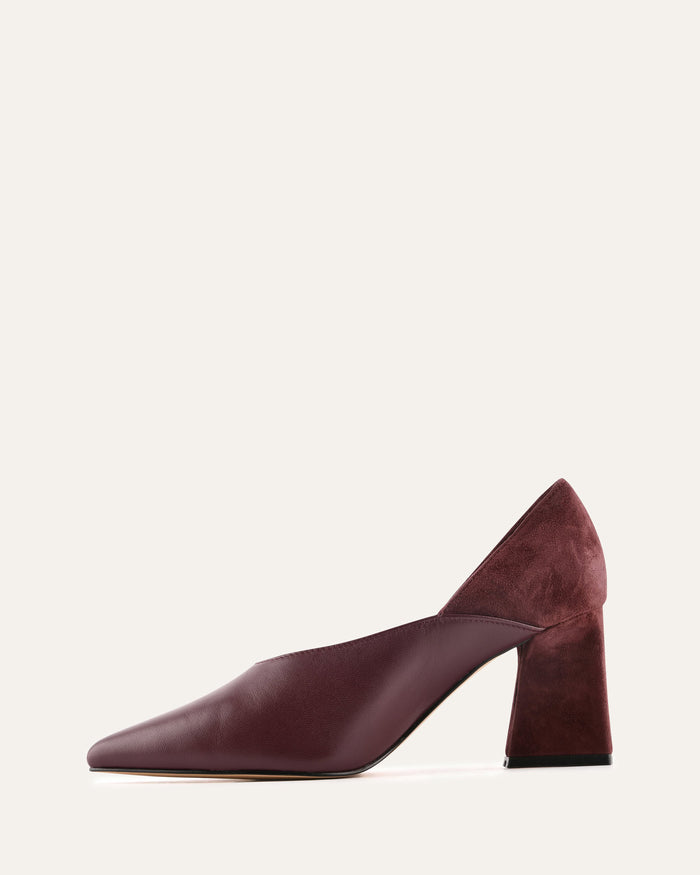 Maroon high-heeled shoe on a light beige background