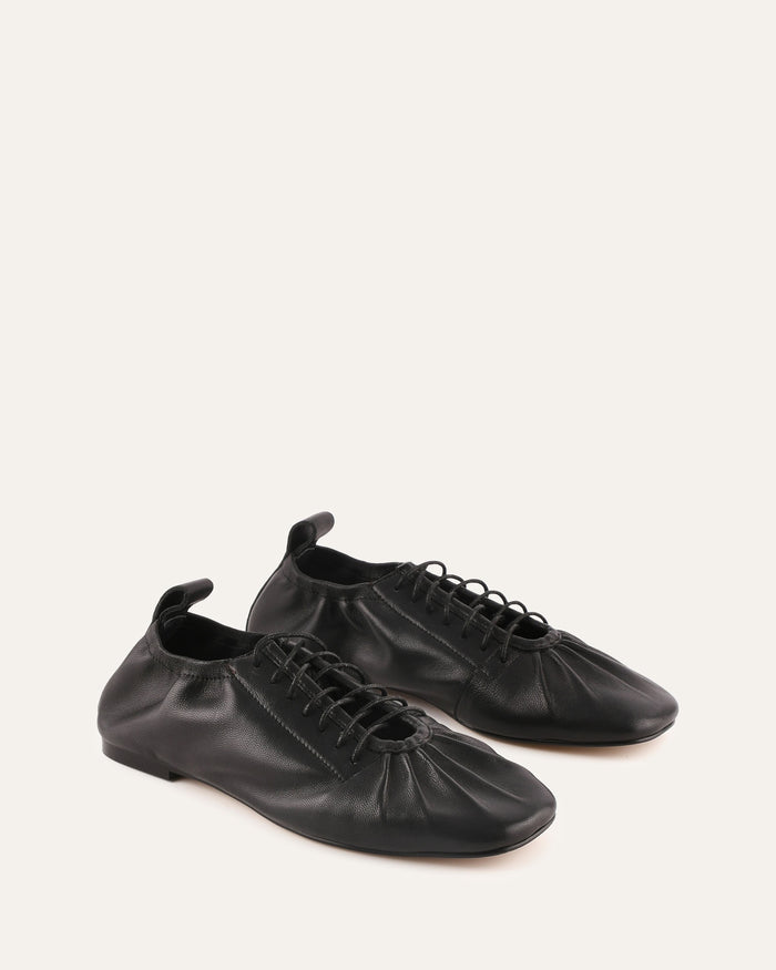 Pair of black leather shoes on a white background