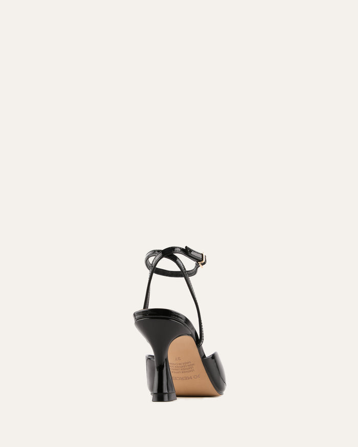 Black high-heeled shoe with a strap on a white background