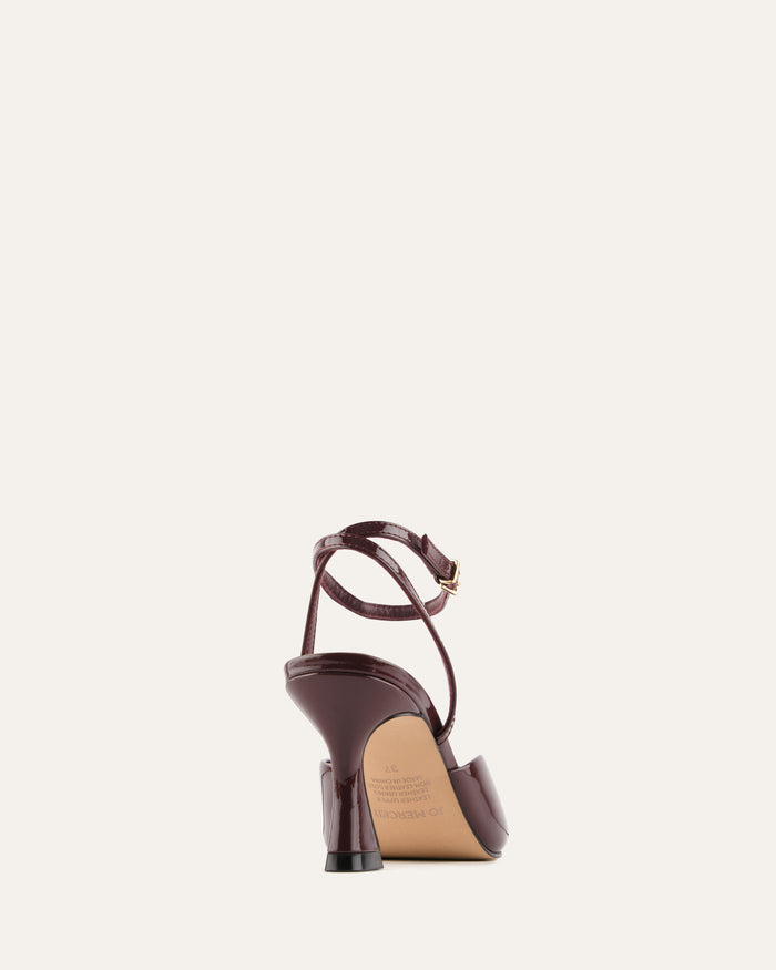 Brown high-heeled sandal on a light beige background