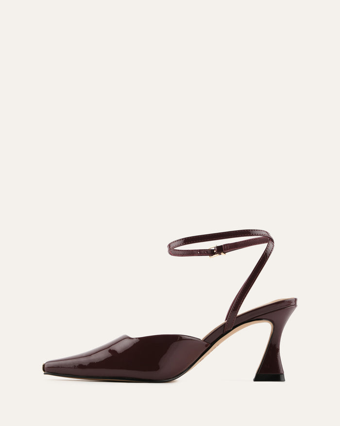 Brown high-heeled shoe with a strap on a white background