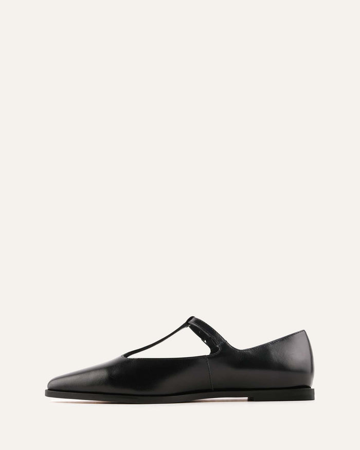 Black leather flat shoe on a white background
