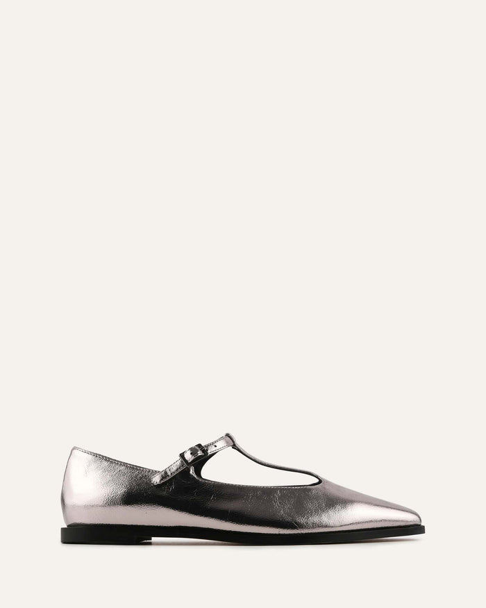 Silver metallic flat shoe with a strap on a white background