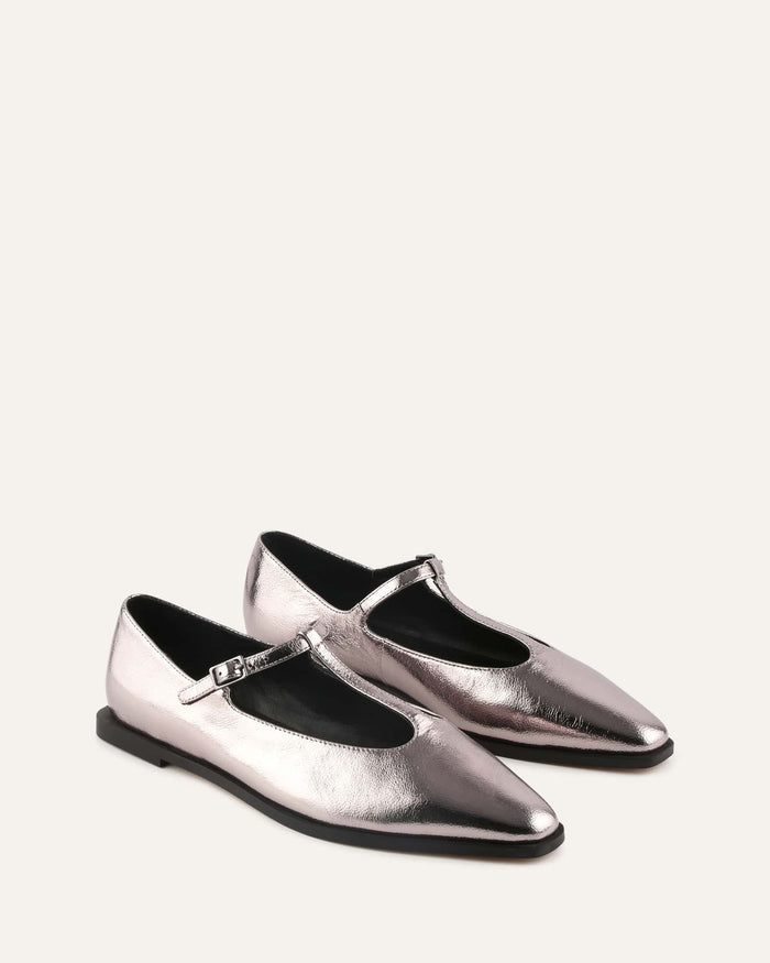 Pair of silver metallic shoes on a white background