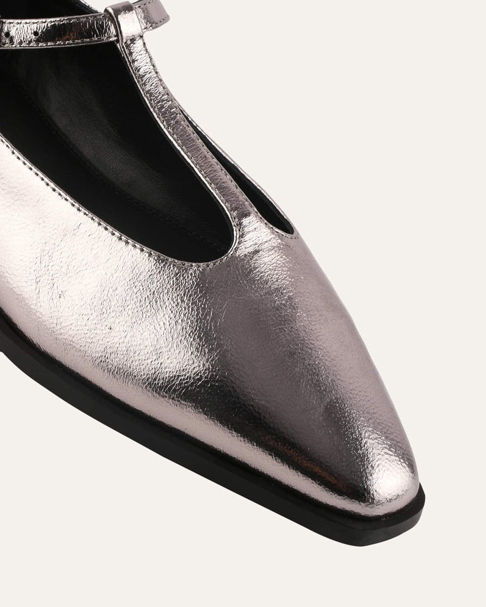 Silver metallic flat shoe with a pointed toe on a white background