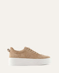 Beige sneaker with a white sole on a light beige background