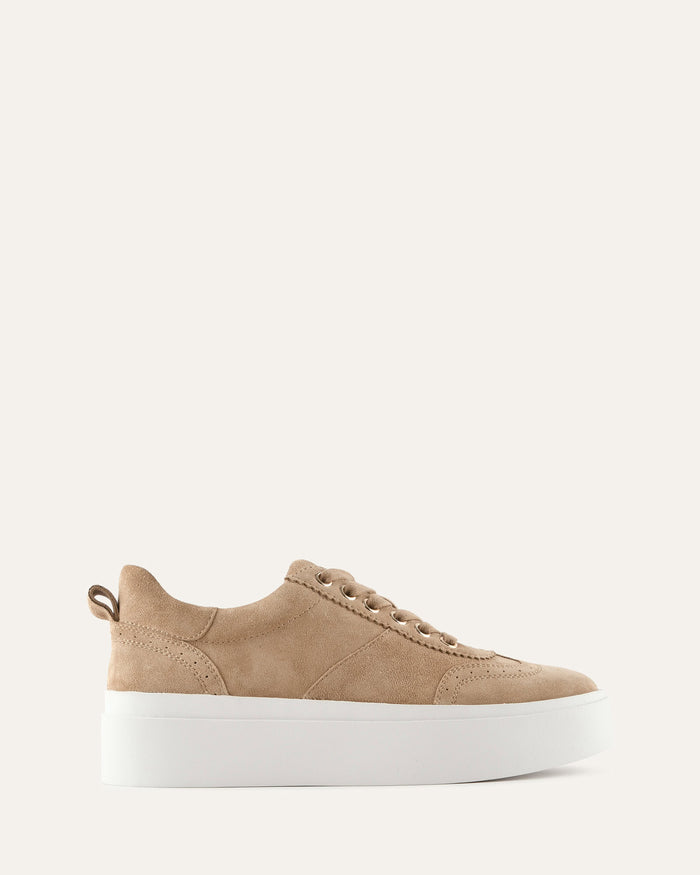 Beige sneaker with a white sole on a light beige background