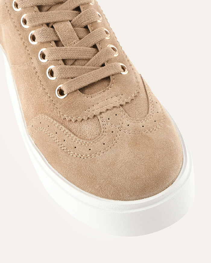 Beige sneaker with white sole on a light gray background