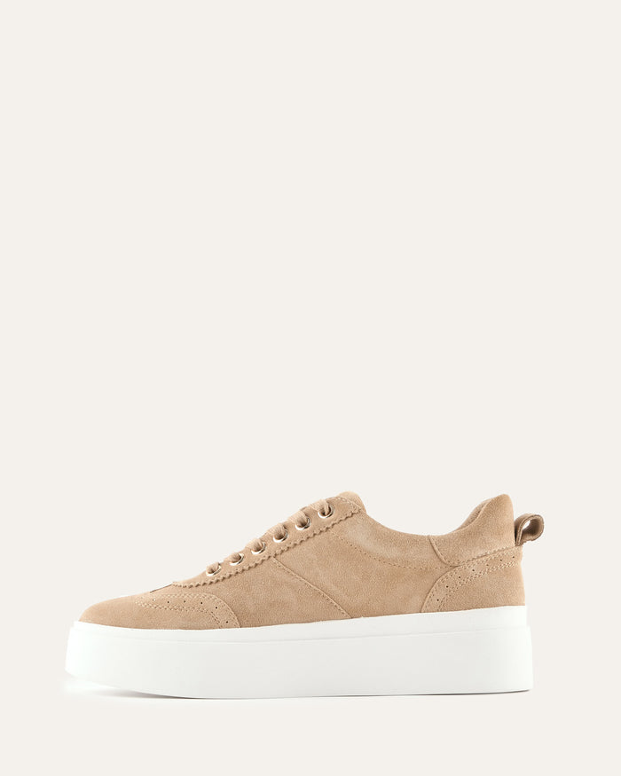 Beige sneaker with a white sole on a light beige background
