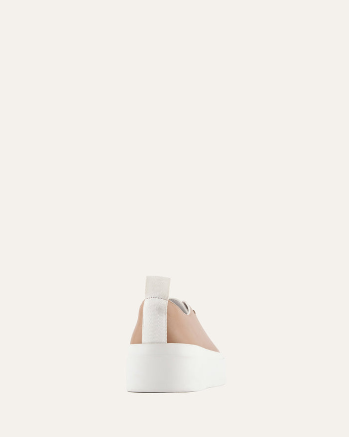 White cylindrical container with a beige cap on a light gray background