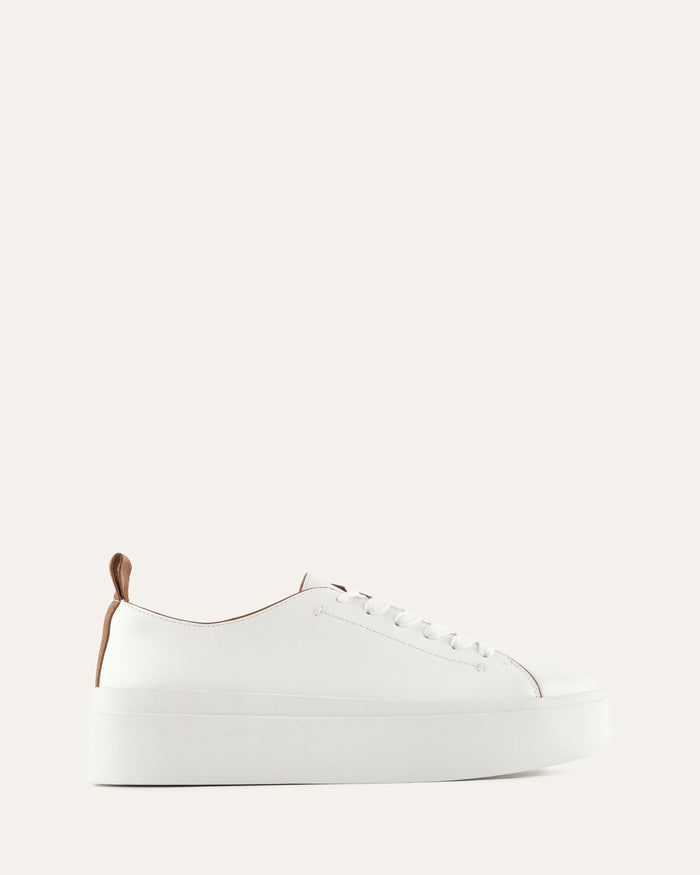 White sneaker on a light beige background