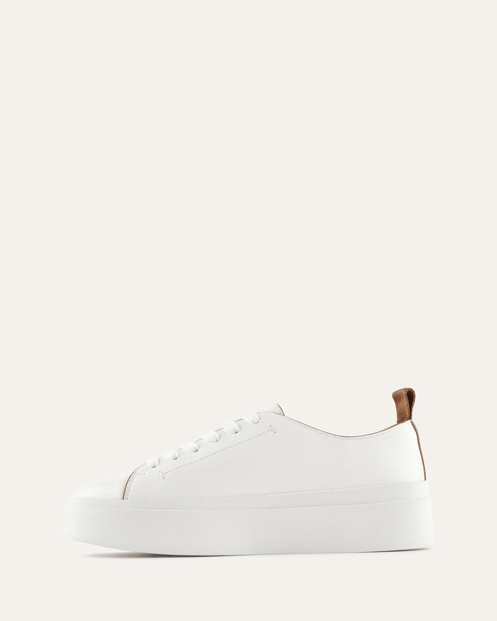 White sneaker with brown accents on a white background