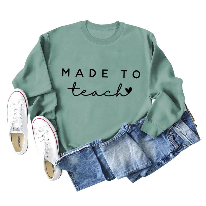 Light green sweater (black font) / S