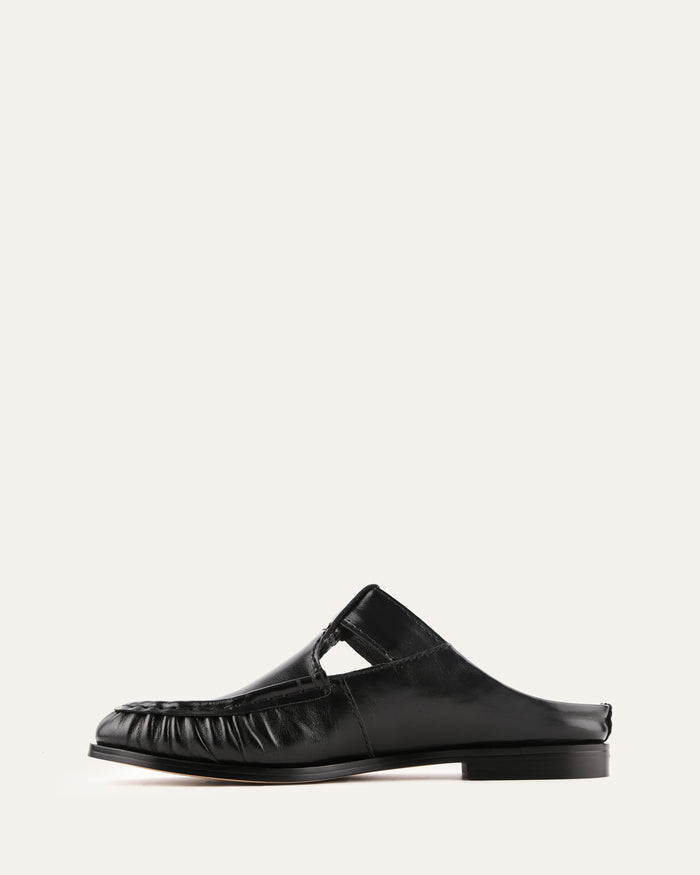 Black leather clog shoe on a white background