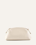 White handbag with gold accents on a light beige background