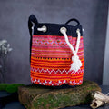Vindigo orange hemp tribal embroidered bucket bag side angle view