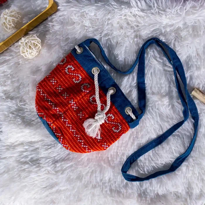 Vindigo red indigo hemp embroidery bag on soft fabric surface