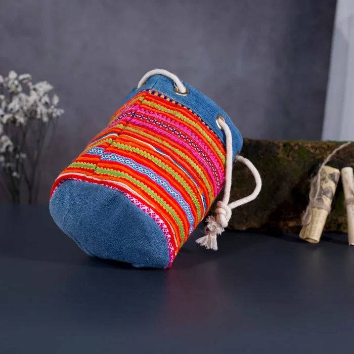 Vindigo orange embroidered canvas bucket bag lying flat view