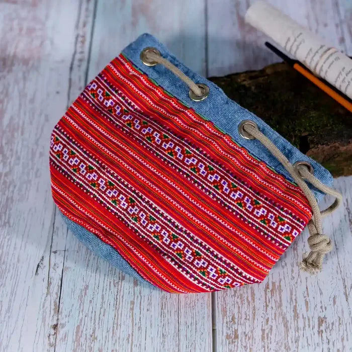 Vindigo red embroidered canvas bucket bag lying flat detail