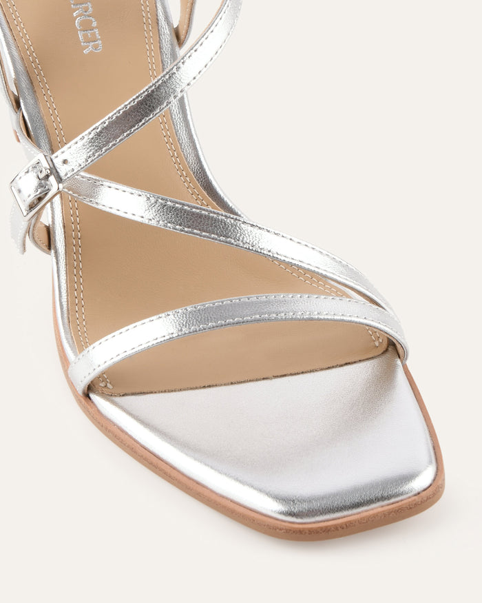 Silver sandal with multiple straps on a white background