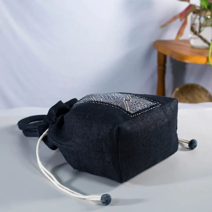 Side view of black hemp bucket bag with vintage H’Mong patch, handmade artisanal design
