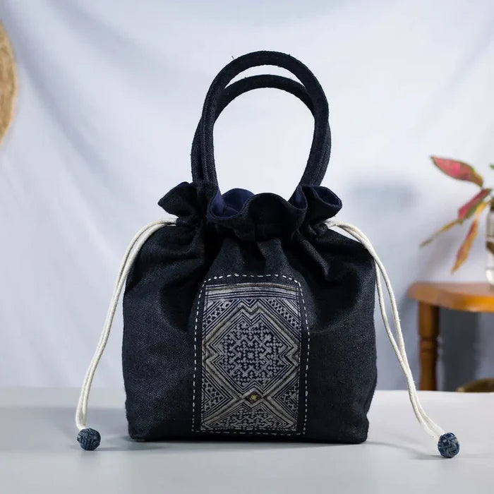Upright view of black hemp bucket bag with vintage H’Mong patch and sturdy fabric handles