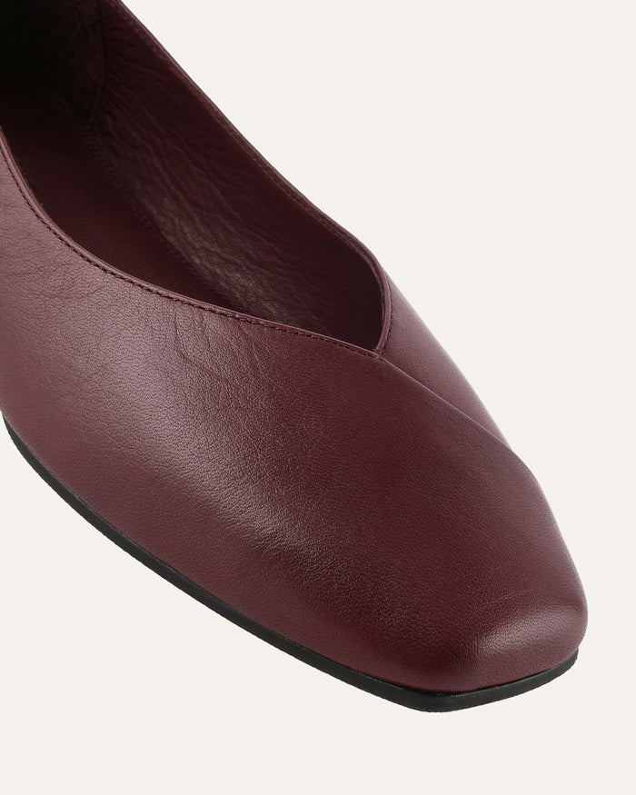 Brown leather flat shoe on a white background