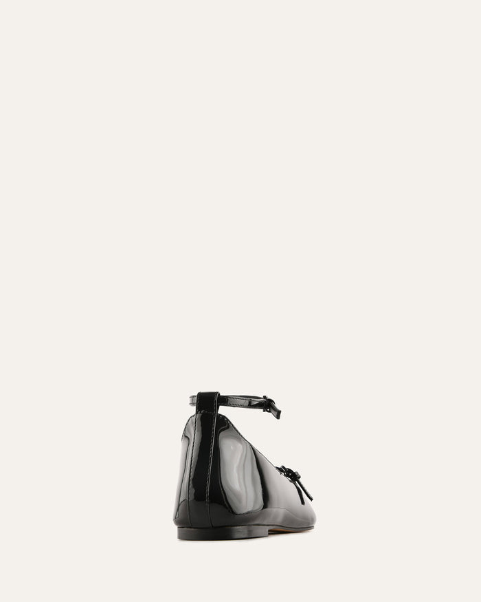 Black shoe with a bow on a white background