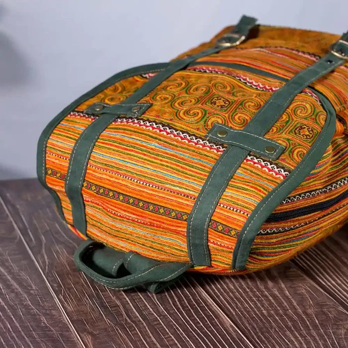 Vindigo yellow embroidered cotton backpack angled view