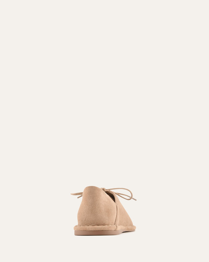 Beige shoe on a light beige background