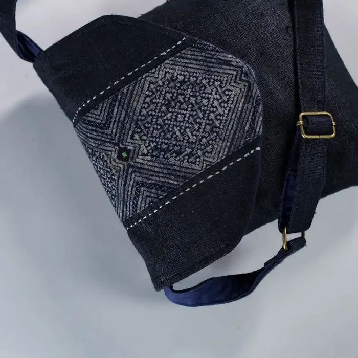 Close-up of H’Mong patch and strap detail on black hemp crossbody bag, eco-friendly handmade design
