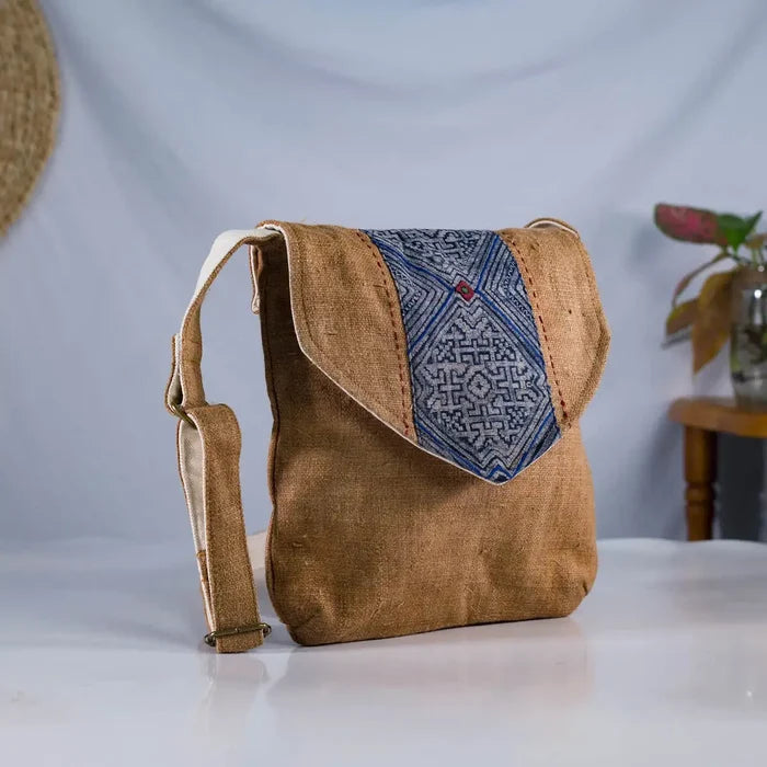 Angled view of brown hemp crossbody bag with vintage patch, sustainable handmade accessory.