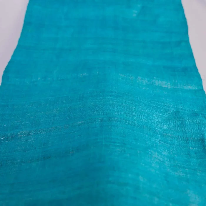 Vindigo turquoise hemp fabric laid flat on white surface