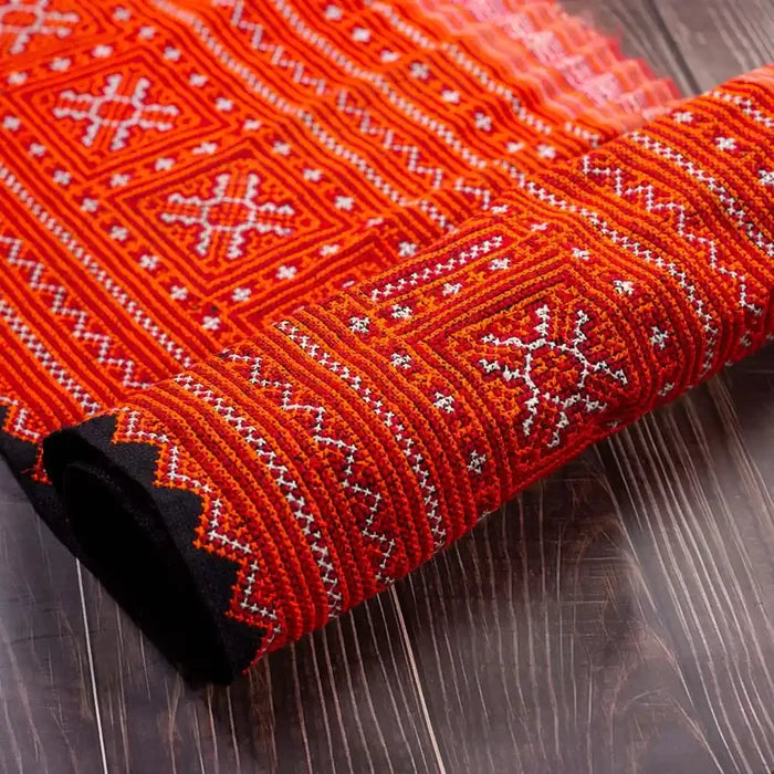 Vindigo red hemp embroidered tribal fabric folded detail close-up
