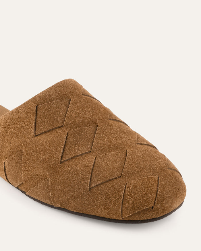 Brown suede slipper with woven pattern on a white background