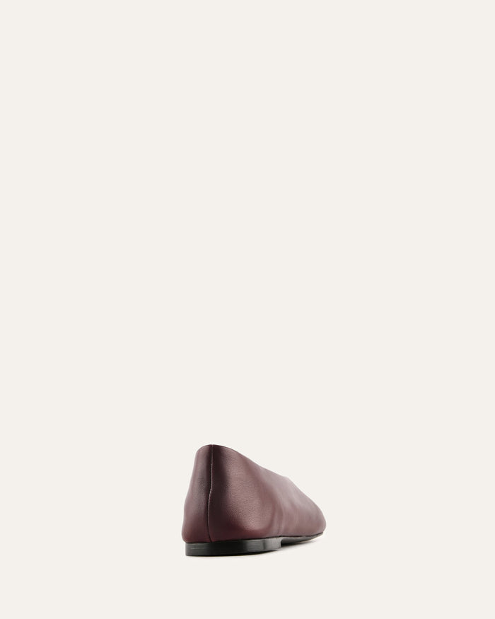 Brown leather beret on a light gray background