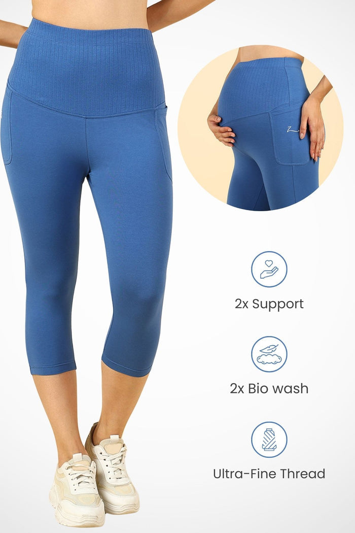 Model wearing Blue Capri; wide ribbed cotton panel stretches comfortably over the pregnant bump.