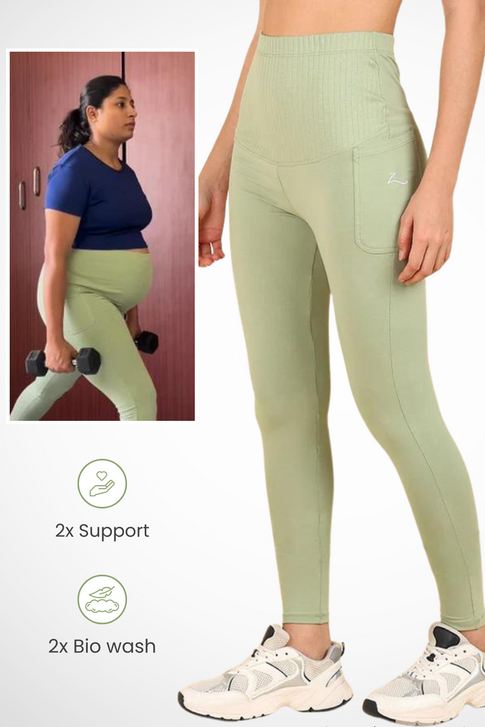 Model wearing Pistachio Ribbed Legging; wide ribbed panel stretches comfortably over the pregnant bump.