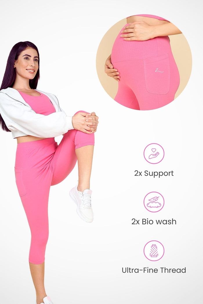Model wearing Pink Capri; wide ribbed cotton panel stretches comfortably over the pregnant bump.