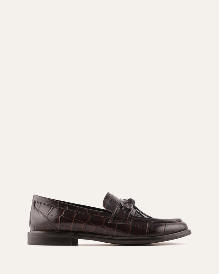 Brown leather loafer shoe on a white background