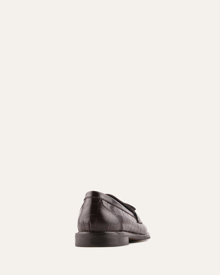Black leather shoe on a white background