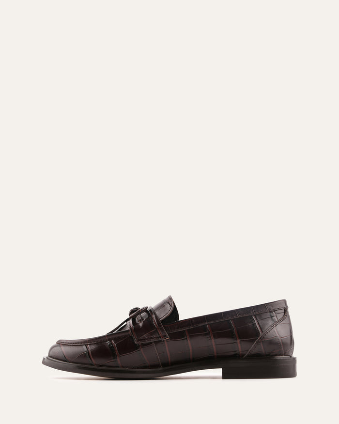 Brown leather loafer shoe on a white background