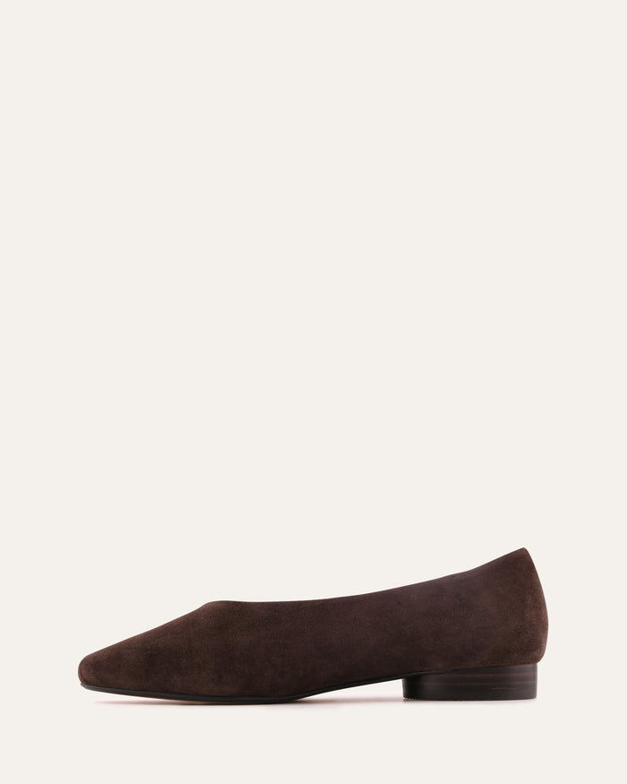 Brown suede flat shoe on a white background