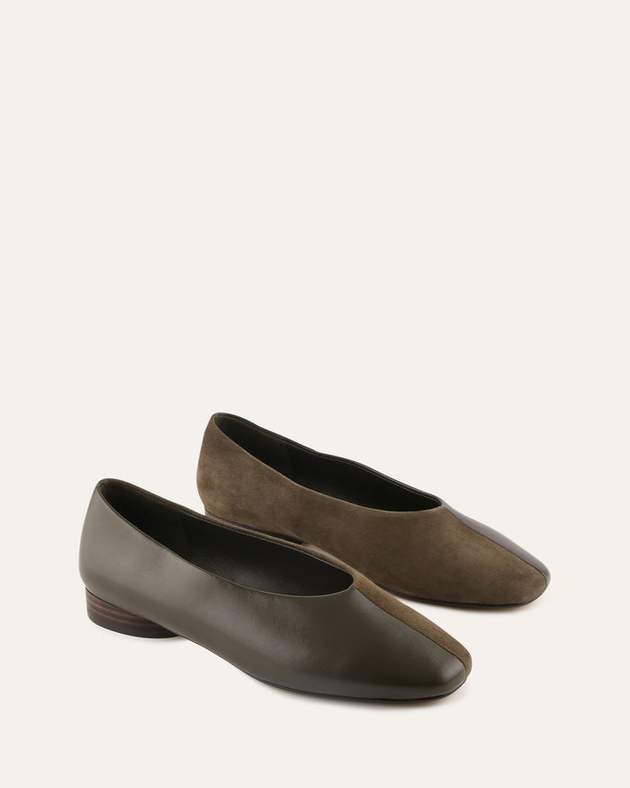 Pair of brown shoes on a light beige background