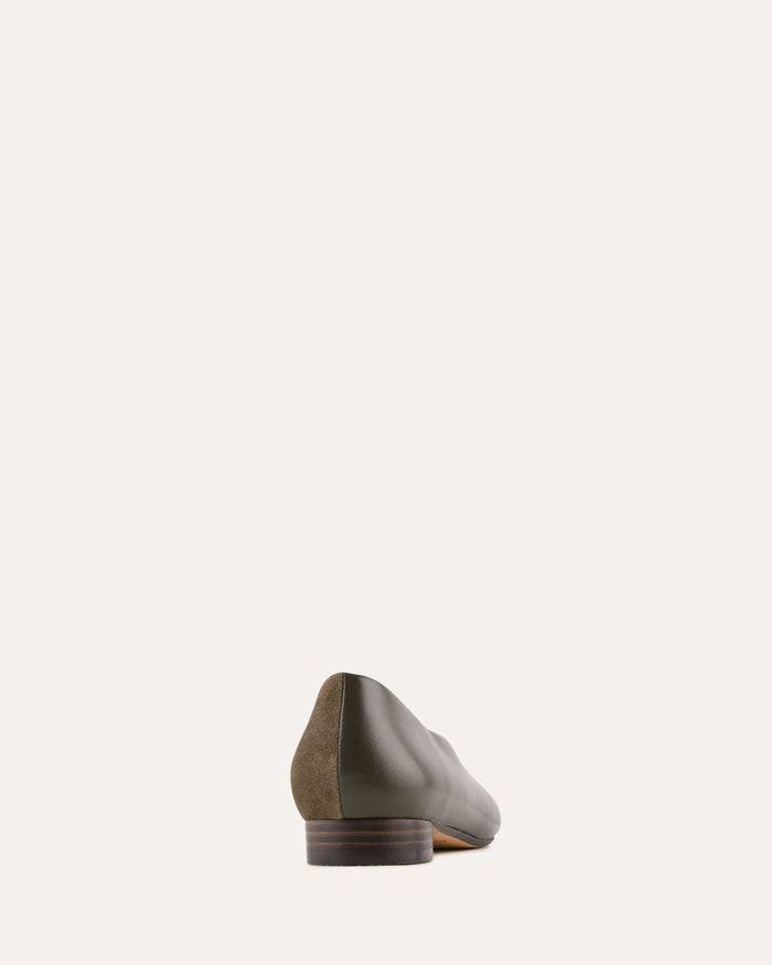 Green leather shoe on a white background